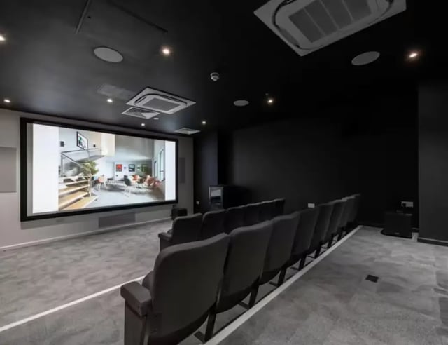 Theater room with projector screen and seating Cinema room at Hollis Croft in Sheffield Student Accommodation