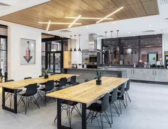 Wooden tables and chairs kitchen area kitchen at Hollis Croft in Sheffield Student Accommodation