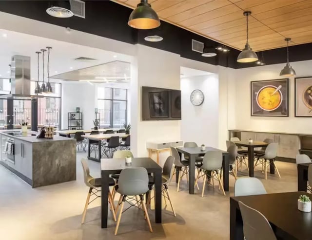 Kitchen and dining tables with chairs communal area at Hollis Croft in Sheffield Student Accommodation