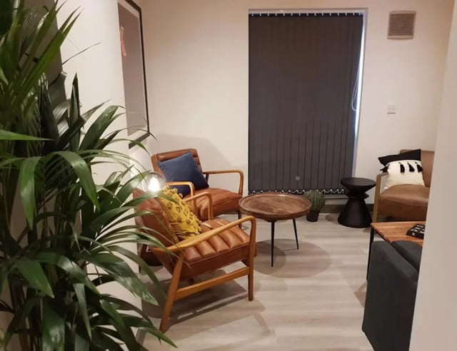 Two leather chairs coffee table living room at St James Point in Newcastle Upon Tyne Student Accommodation
