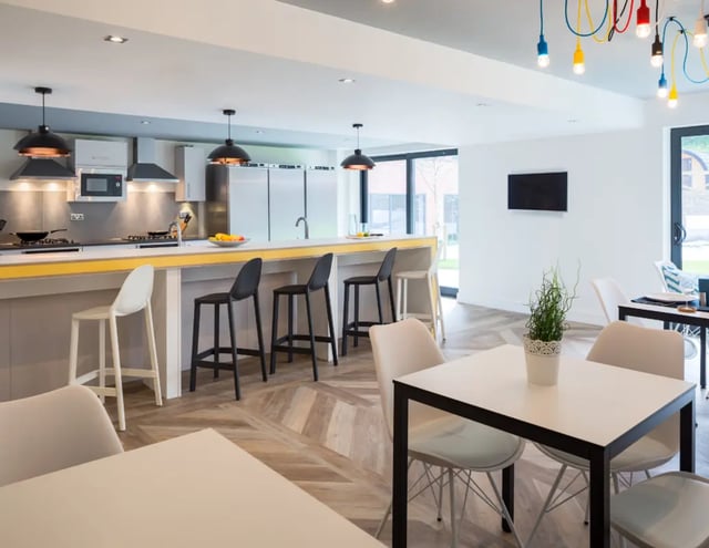 Modern kitchen with breakfast bar and dining area Living room at The Glassworks - Leeds in Leeds Student Accommodation