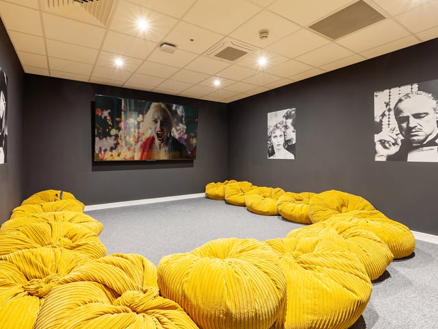 Yellow beanbags before large screen movie room at Hill View Place in Exeter Student Accommodation