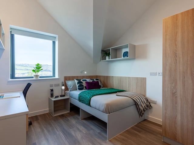 Bed desk chair window wardrobe bedroom at Hill View Place in Exeter Student Accommodation