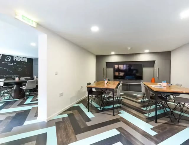 Tables chairs and television common area living room at Central Place in Sheffield Student Accommodation