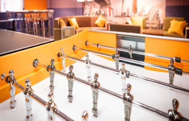 Foosball table with players and table in background living room at Albert Place in Newcastle Upon Tyne Student Accommodation