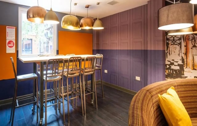 High table with chairs and sofa communal area at Albert Place in Newcastle Upon Tyne Student Accommodation