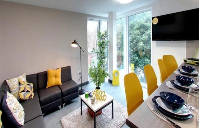 Sofa coffee table plant and yellow chairs living room at Albert Place in Newcastle Upon Tyne Student Accommodation