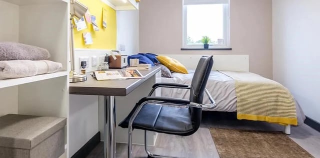 Desk chair bed towels and shelves bedroom at Albert Place in Newcastle Upon Tyne Student Accommodation