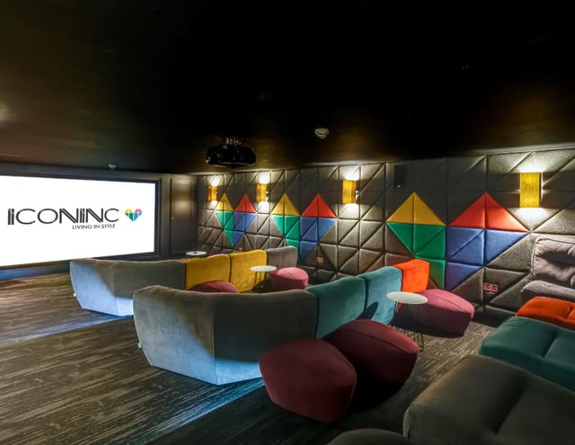Large screen projector sofas colorful wall movie room at The Edge - Leeds in Leeds Student Accommodation