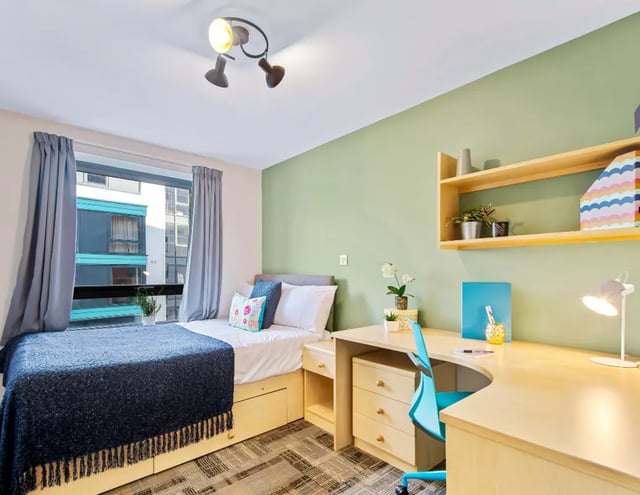 Bed with storage desk chair and shelf bedroom at Iconinc The Triangle in Leeds Student Accommodation