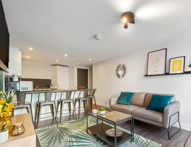 Sofa coffee table kitchen island stools living room at Iconinc The Triangle in Leeds Student Accommodation