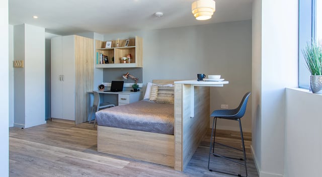 Bed desk wardrobe and breakfast bar bedroom at Renslade House in Exeter Student Accommodation