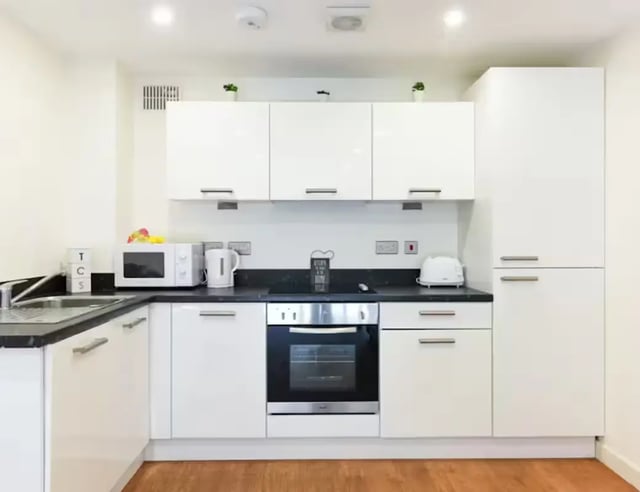 White cabinets microwave kettle oven toaster kitchen at Mellor House - Central Place in Sheffield Student Accommodation