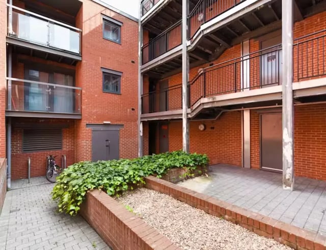 Brick building with balconies and bike rack exterior at Mellor House - Central Place in Sheffield Student Accommodation