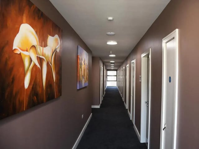 Hallway with art doors and carpet hallway at Pembroke Studios in Liverpool Student Accommodation