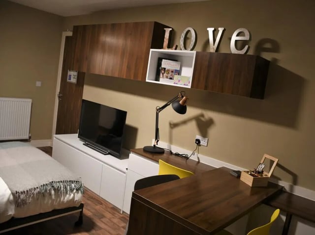 Bed desk lamp and television in room at Pembroke Studios in Liverpool Student Accommodation