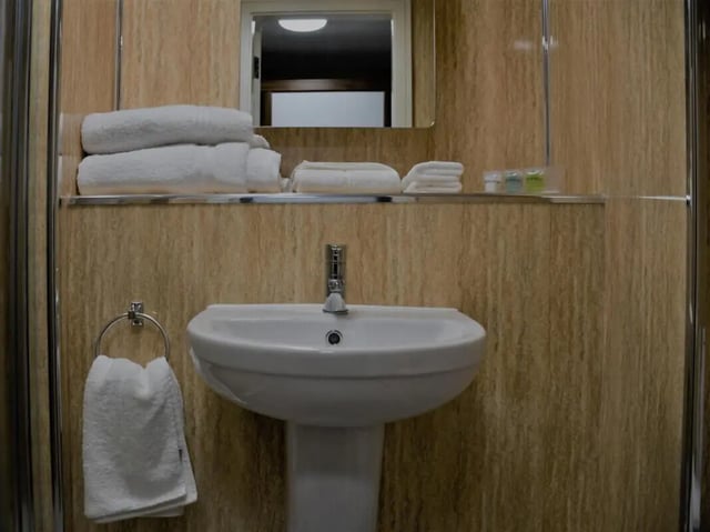 Sink with towels mirror and toiletries bathroom at Pembroke Studios in Liverpool Student Accommodation