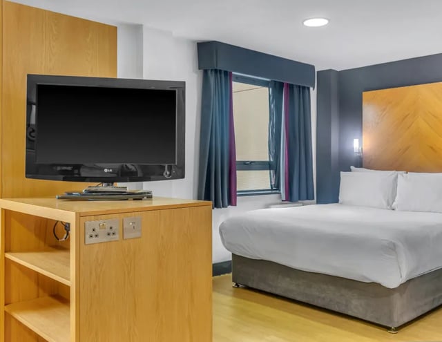 Television and bed in student accommodation bedroom at Iconinc Leeds City West in Leeds Student Accommodation