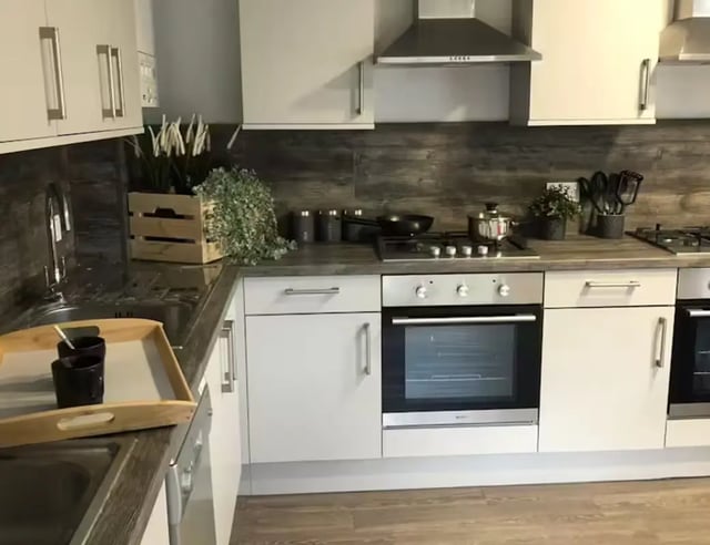 Sink oven cabinets with wooden accents kitchen at Solly House - Central Place in Sheffield Student Accommodation