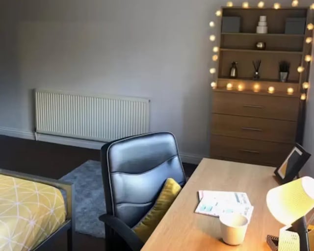 Bed chair desk radiator fairy lights study area at Solly House - Central Place in Sheffield Student Accommodation