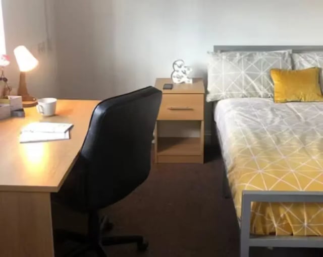 Desk chair bedside table and bed Bedroom at Solly House - Central Place in Sheffield Student Accommodation