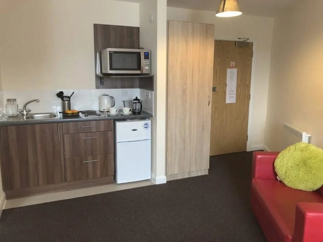 Kitchenette with microwave fridge and sofa living room at Jubilee Court in Preston Student Accommodation
