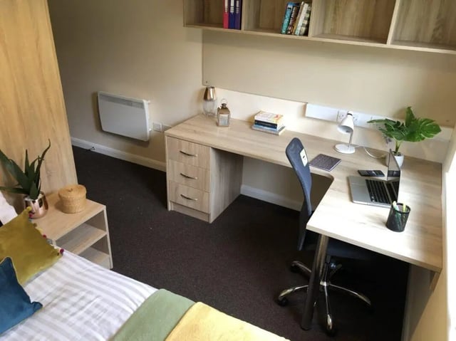 Bed desk chair bookshelf and heater Bedroom at Jubilee Court in Preston Student Accommodation