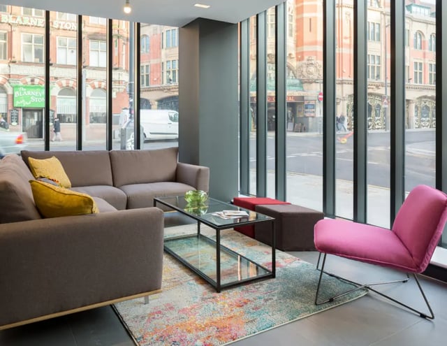 Sofa coffee table colorful rug chair living room at The Ascent in Liverpool Student Accommodation