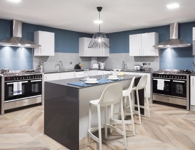 Modern student kitchen with island bar stools cooking appliances kitchen at The Ascent in Liverpool Student Accommodation