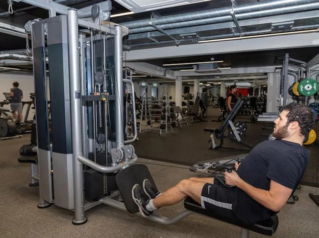 Gym equipment with man working out fitness area at Powis Place in Aberdeen Student Accommodation