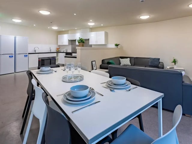 Dining table kitchen fridges sofas living room at Powis Place in Aberdeen Student Accommodation