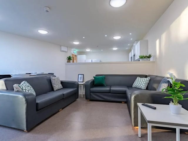 Two dark sofas with patterned pillows living room at Powis Place in Aberdeen Student Accommodation