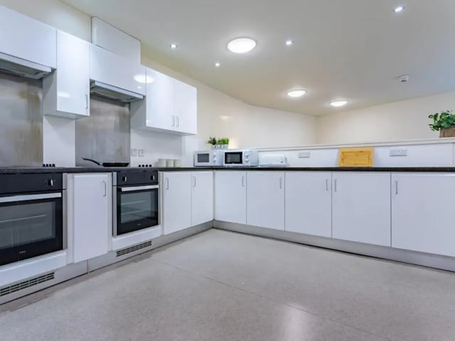 Modern kitchen with white cabinets and ovens kitchen at Powis Place in Aberdeen Student Accommodation