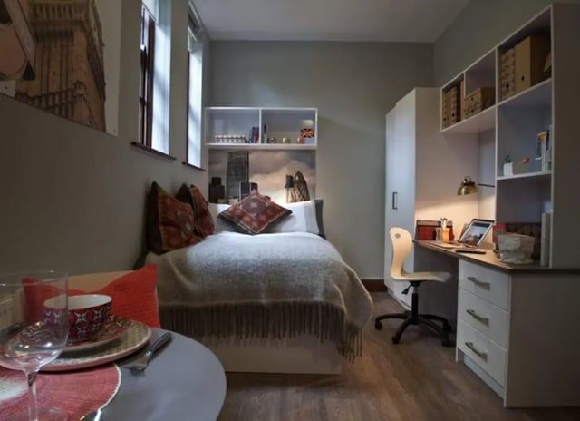 Bed with desk and shelves bedroom at Powis Place in Aberdeen Student Accommodation