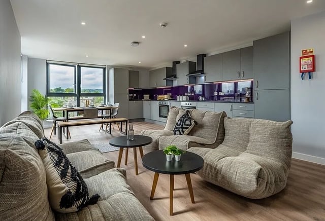 Modern living room kitchen with sofas and dining table interior at Carters Yard in Stirling Student Accommodation