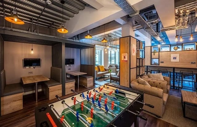 Foosball table seating booths couches living room at Carters Yard in Stirling Student Accommodation