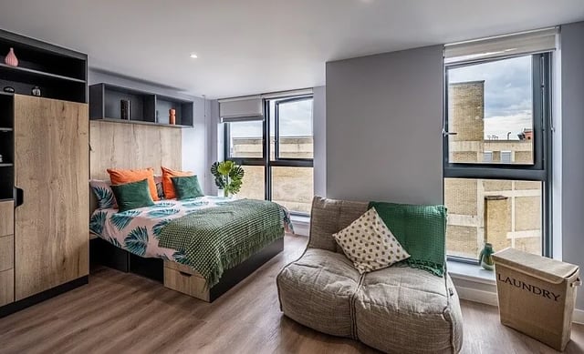 Bed sofa laundry basket and wardrobe Bedroom at Carters Yard in Stirling Student Accommodation
