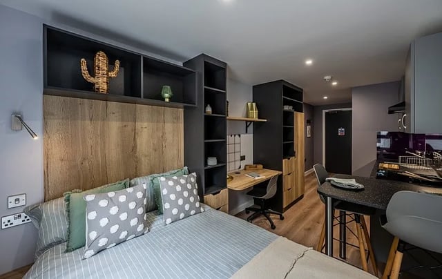 Bed desk and kitchen area studio apartment at Carters Yard in Stirling Student Accommodation