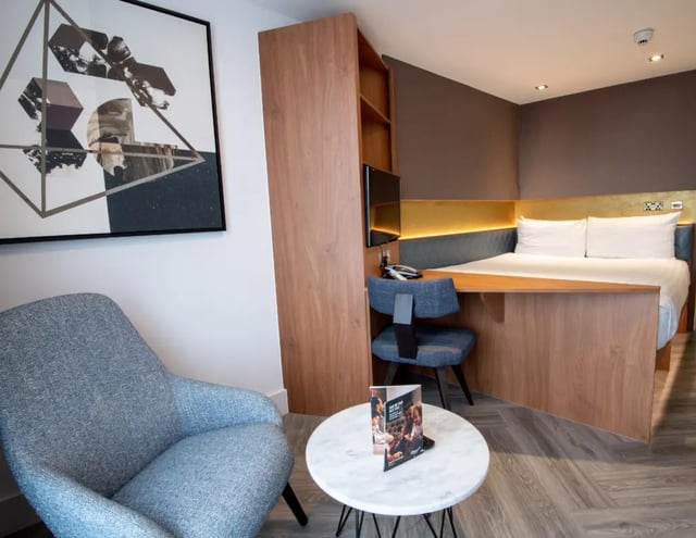 Bed desk chair with painting and chair Bedroom at IconInc London Stratford in London Student Accommodation