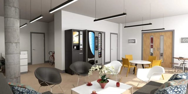 Vending machines chairs tables and gym sign communal area at Nebula in Sheffield Student Accommodation