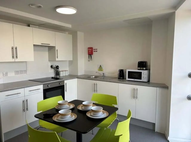 Kitchen with dining table and chairs kitchen at Nebula in Sheffield Student Accommodation