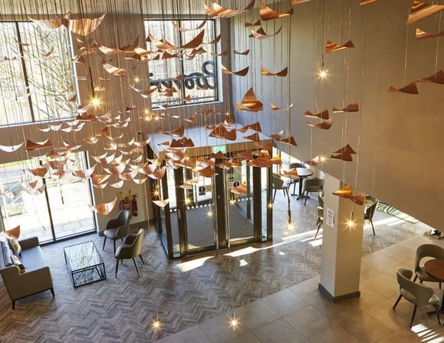 Modern lobby seating area with unique ceiling light installation interior at IconInc York City in York Student Accommodation