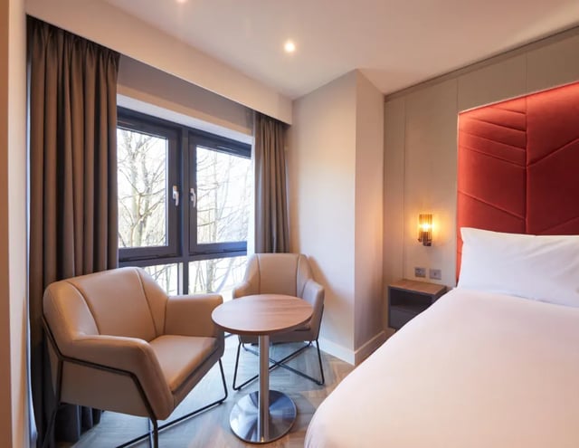 Two armchairs table and bed bedroom at IconInc York City in York Student Accommodation