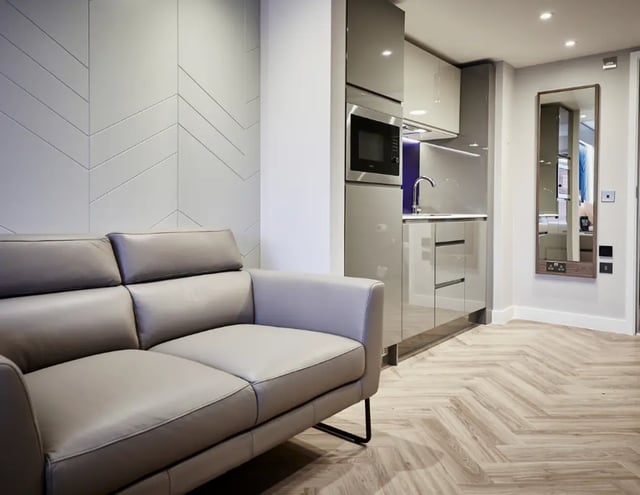 Sofa kitchen microwave and mirror living room at IconInc York City in York Student Accommodation