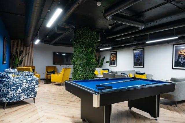 Pool table sofa seating yellow armchairs living room at Boutique Student Living Swansea in Swansea Student Accommodation