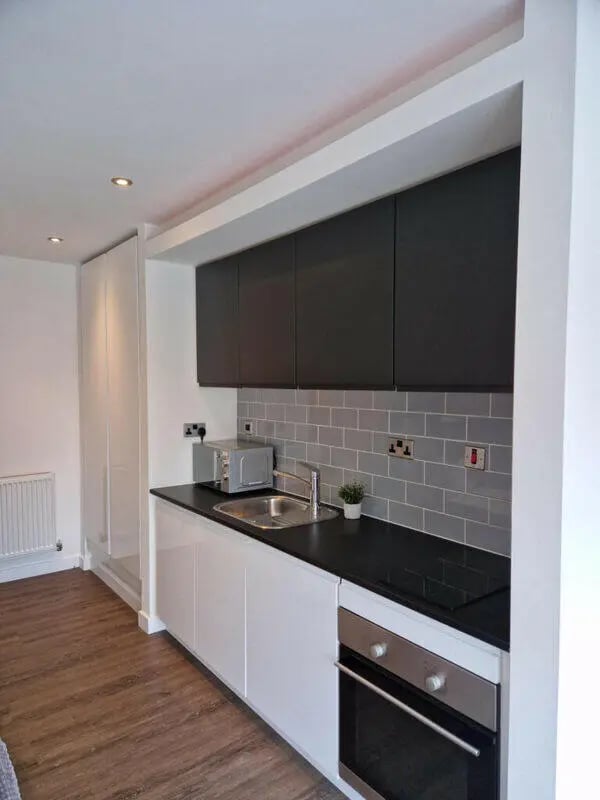 Modern kitchen with microwave oven sink and cabinets kitchen at Printworks in Sheffield Student Accommodation