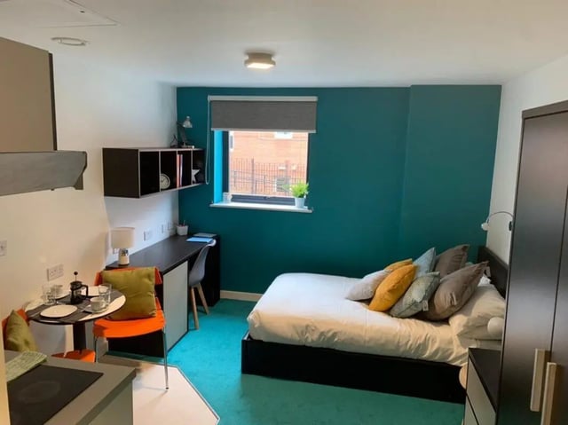Bed desk chair shelf and small table bedroom at Plato House in Liverpool Student Accommodation