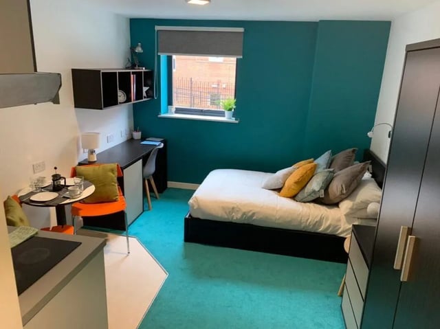 Bed desk dining area kitchen wardrobe bedroom at Plato House in Liverpool Student Accommodation