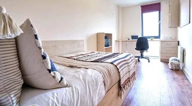Bed desk chair and bookshelf student bedroom at Rockingham House in Sheffield Student Accommodation