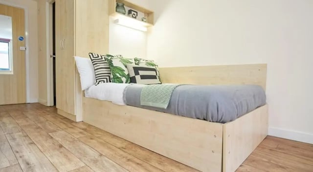 Bed with pillows and blanket then bedroom at Rockingham House in Sheffield Student Accommodation